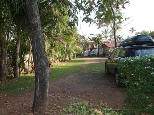 a car parked next to a row of palm trees at Santonio Resorts in Anjuna
