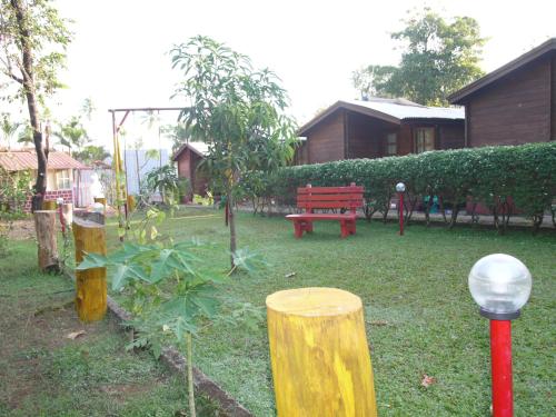 a park with a bench and trees and a house at Santonio Resorts in Anjuna
