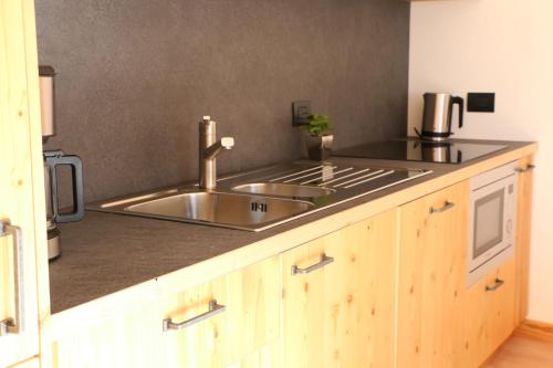 a kitchen with a sink and a counter top at Appartamenti Forhotel in Livigno