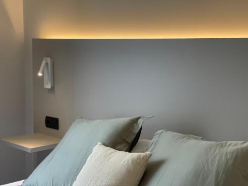 a white bed with two pillows on it at VTZ Hotel San Valero in Zaragoza