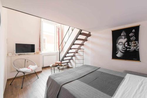 a bedroom with a large bed and a staircase at Little House in the centre Nettuno in Nettuno