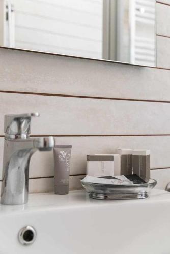 a bathroom counter with a sink and a mirror at Little House in the centre Nettuno in Nettuno