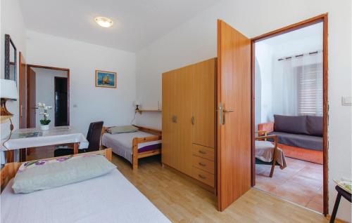 a room with a bedroom with a bed and a desk at Amazing Apartment In Kostrena With Wifi in Kostrena