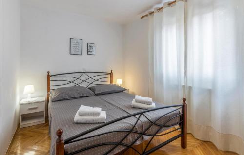 a bedroom with a bed with two towels on it at 3 Bedroom Gorgeous Home In Labin in Labin