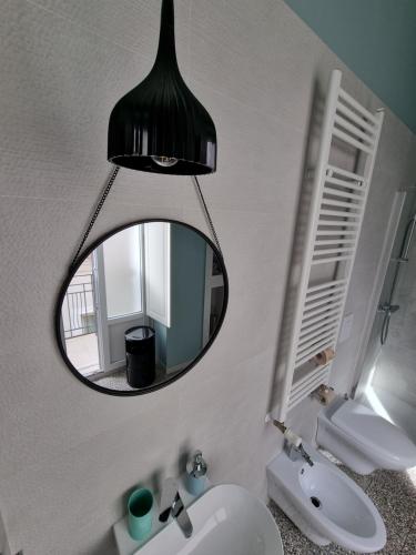 a bathroom with a mirror and a sink at B&B Novecento Italiano in Altamura
