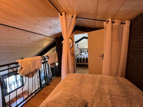a bedroom with a bed and a balcony with a window at chalet de l ours in Bolquere Pyrenees 2000
