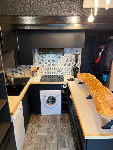 a kitchen with a washing machine and a sink at chalet de l ours in Bolquere Pyrenees 2000