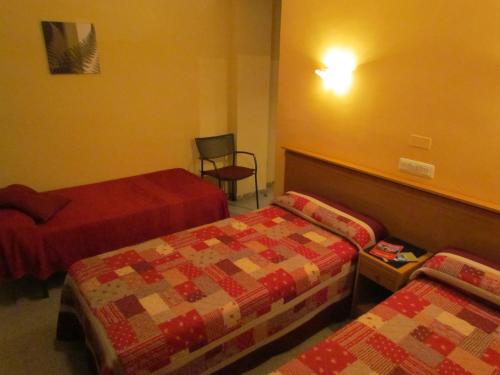 Postel nebo postele na pokoji v ubytování Hostal Las Rumbas