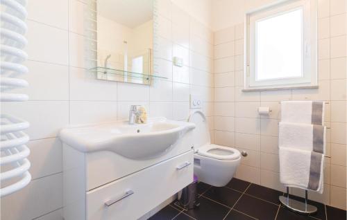 a white bathroom with a sink and a toilet at 3 Bedroom Awesome Home In Fazana in Fažana