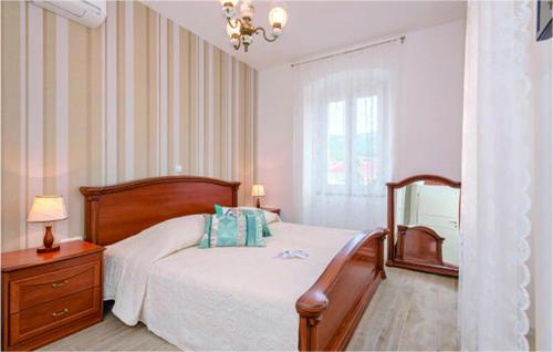 a bedroom with a bed and a dresser and a mirror at Cozy Home In Jelsa With Private Swimming Pool, Can Be Inside Or Outside in Jelsa