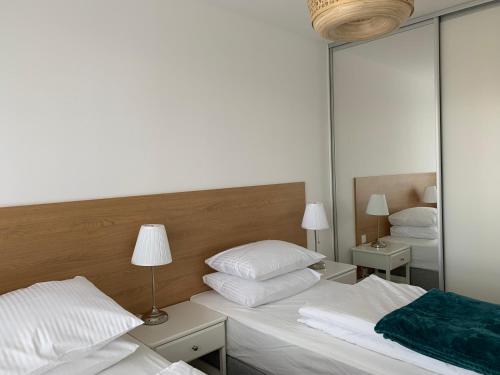 a bedroom with two beds and a large mirror at Apartamenty Bliska 33 in Bielsko-Biala