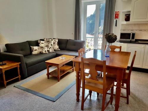 a living room with a table and a couch at Casa da Capelinha in Ponta Delgada