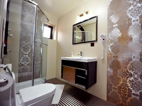 a bathroom with a sink and a shower at Pensiunea Ellemar in Vatra Dornei