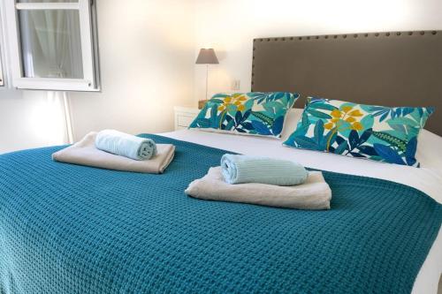 a bedroom with two beds with towels on them at Ma villa en Provence villa de standing et piscine Domaine de Pont-Royal in Mallemort