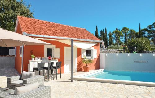 a backyard with a swimming pool and a house at Lovely Home In Zedno With Wifi in Trogir