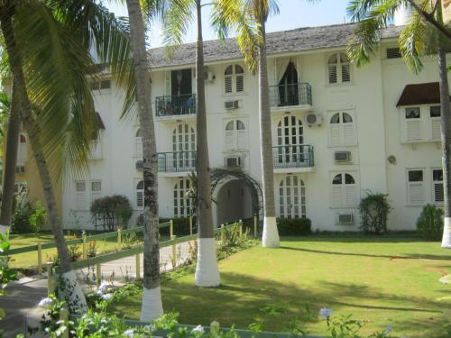a building with palm trees in front of it at Ocho Rios Vacation Resort Property Rentals in Ocho Rios