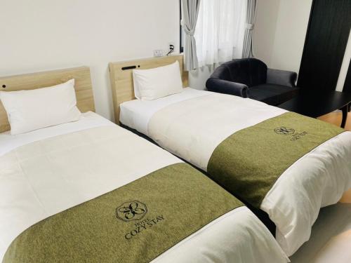 Postel nebo postele na pokoji v ubytování HOTEL Y'RISE TO URASOE
