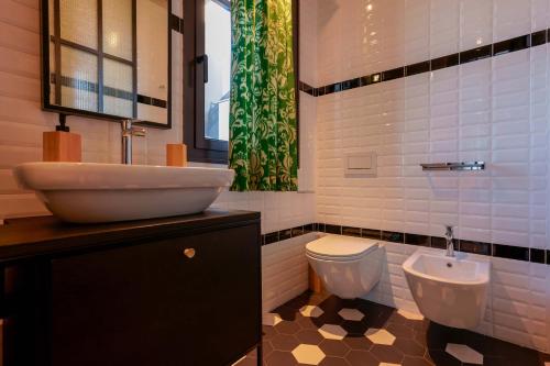 a bathroom with a sink and a toilet at Skyline 1/7 B&B in Bologna