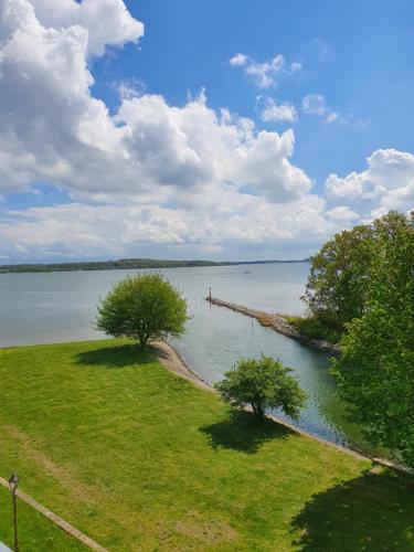 a view of a body of water with trees and a dock at Hotel Dänholm in Stralsund