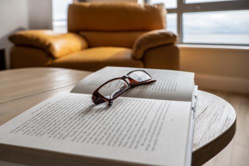 a pair of glasses sitting on top of a book at Galway Bay Sea View Apartments in Galway