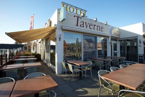 a row of tables and chairs outside of a restaurant at Vivaldi Hotel in Westerlo