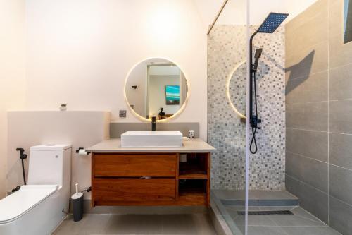 a bathroom with a sink and a mirror at One Bay Residence - Apartment 2 - Apartment in Pereybere in Pereybere