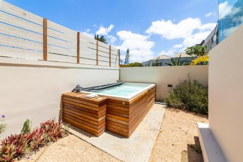 a hot tub sitting on the side of a house at One Bay Residence - Apartment 2 - Apartment in Pereybere in Pereybere