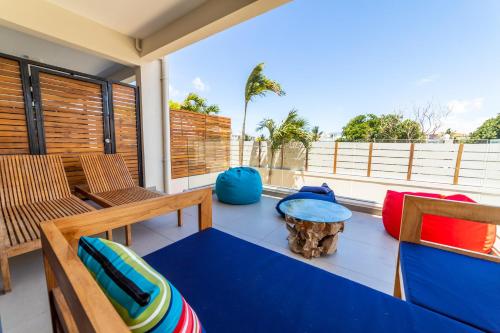 a balcony with a table and chairs on a balcony at One Bay Residence - Apartment 2 - Apartment in Pereybere in Pereybere