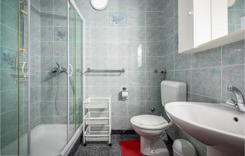 a bathroom with a toilet and a sink and a shower at Cozy Apartment In Vrsar With Kitchen in Vrsar