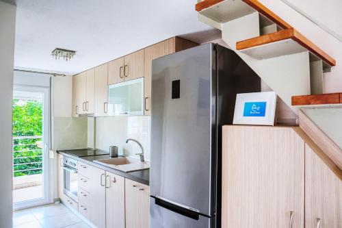 a kitchen with a stainless steel refrigerator and a sink at PerissaHouse Studio in Nikiti