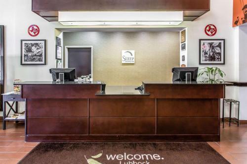 a lobby with a reception desk with a welcome sign at Sleep Inn & Suites Lubbock West in Lubbock