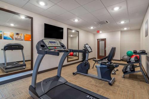 a gym with two treadmills and two exercise bikes at Comfort Suites in Newnan