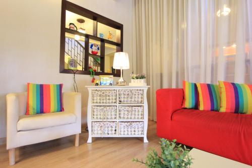 a living room with two chairs and a dresser at Vista Rio - Scenic River View, Walk to Jonker St in Melaka