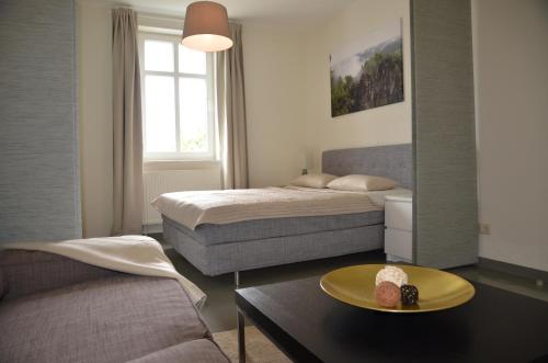En eller flere senge i et værelse på Villa Heimathafen