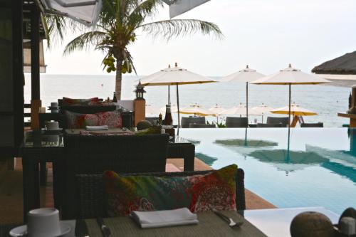 a restaurant with a view of the ocean and a pool at Samui Jasmine Resort - SHA Plus in Lamai