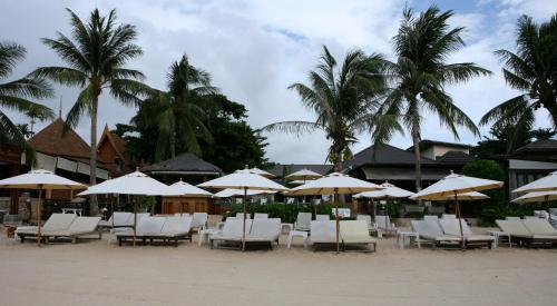 a bunch of chairs and umbrellas on a beach at Samui Jasmine Resort - SHA Plus in Lamai