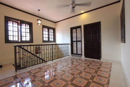 an empty room with a staircase and a door at Vista Rio - Scenic River View, Walk to Jonker St in Melaka
