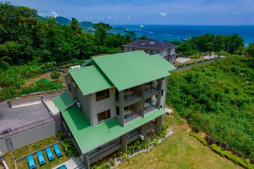 an overhead view of a house with a green roof at Hidden Valley Residence in Au Cap
