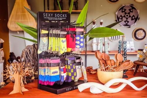 a rack filled with different colored pens on a table at Bushveld Terrace Safari Hotel, Lodge & Spa in Phalaborwa