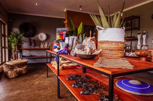 a room with a table with a vase on it at Bushveld Terrace Safari Hotel, Lodge & Spa in Phalaborwa
