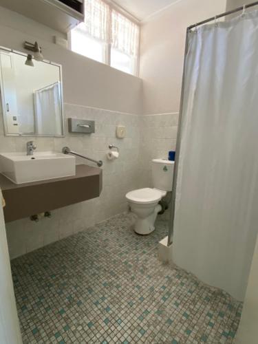 a bathroom with a toilet and a sink and a shower at Warrina Motor Inn Wodonga CBD in Wodonga