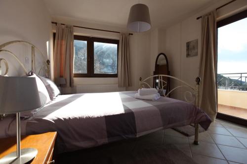 a bedroom with a large bed and a window at Gerania Villa in Písia