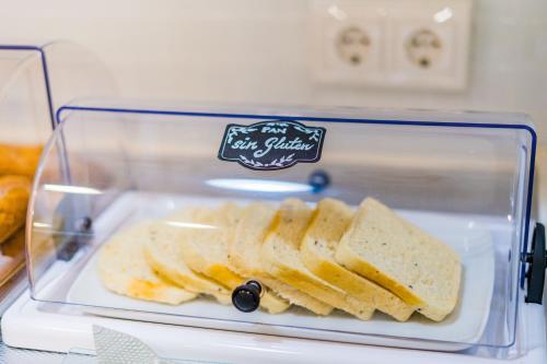 a plastic container filled with bread on top of a refrigerator at Hotel Costasol in Almería