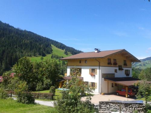 a house in the middle of a mountain at Frühstückspension Wagrain - Viktoria Flasch in Wagrain