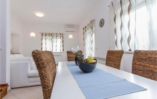 a dining room table with a bowl of bananas on it at Nice Home In Drenje With 4 Bedrooms, Wifi And Outdoor Swimming Pool in Drenje