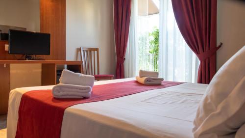 Ένα ή περισσότερα κρεβάτια σε δωμάτιο στο Hotel Venezia Park - ENJOY HOLIDAY