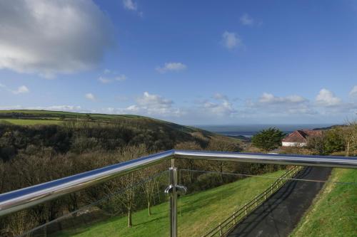 a view of the countryside from the balcony of a house at Hazelmere - Woolacombe-4 Bed-Sleeps 10-TJSHH in Woolacombe
