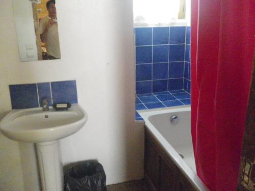 a bathroom with a sink and a toilet and a tub at Manoir de la Baronnie in Marcei