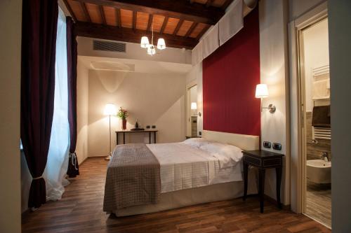 a hotel room with a bed and a dresser at Grand Hotel Impero Spa & Resort in Castel del Piano