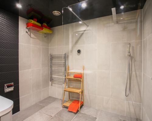 a bathroom with a shower with a ladder in it at Claron Lodge in West Wittering